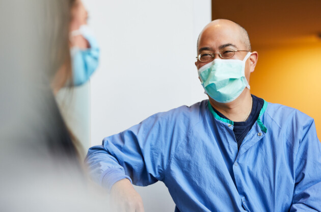 a bald doctor wearing a mask.