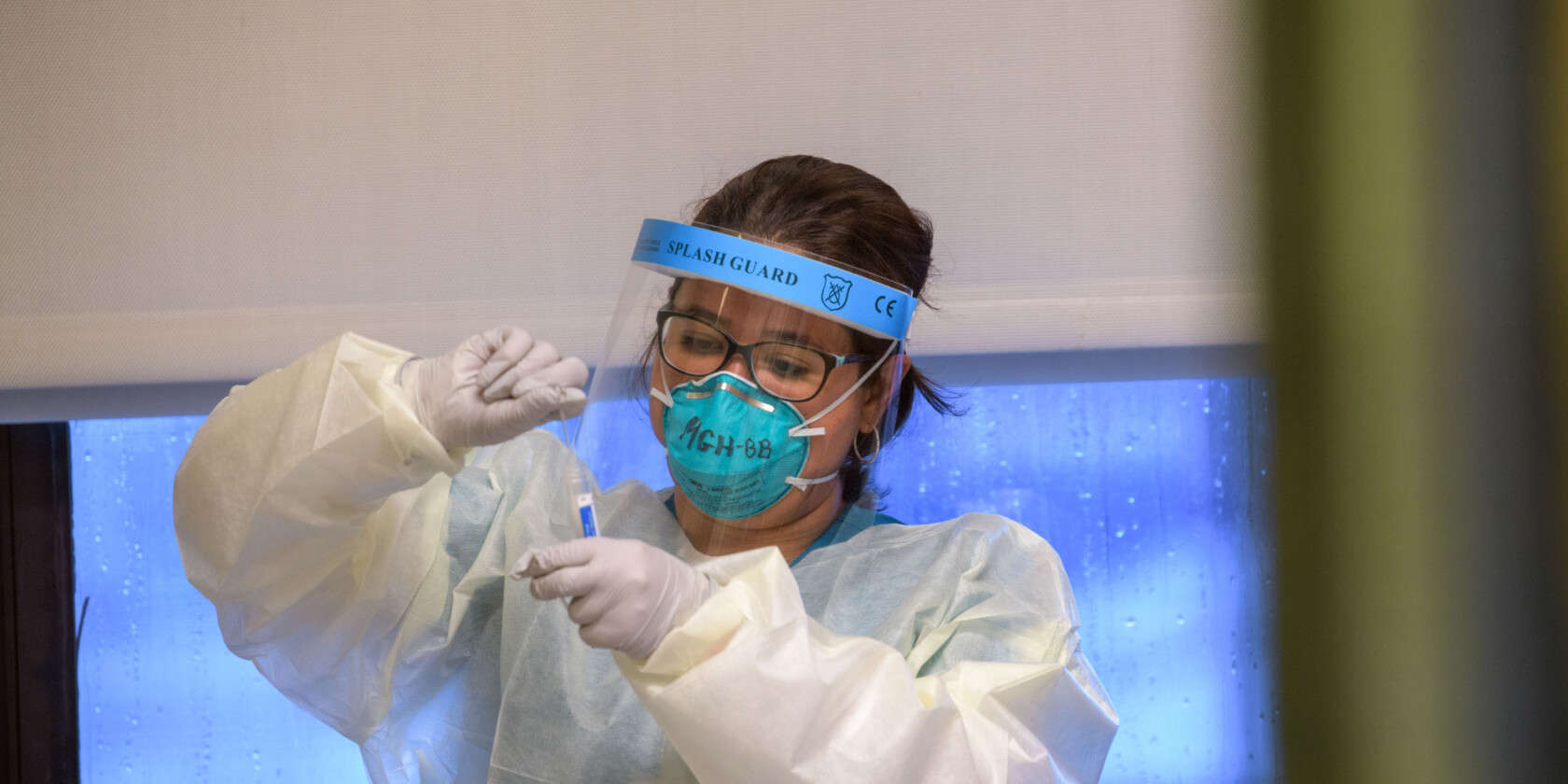 Woman with mask doing labwork.